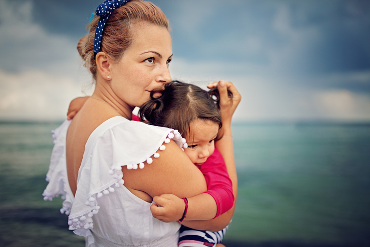 Picture of a mother embracing her child after Hurricane Helene.